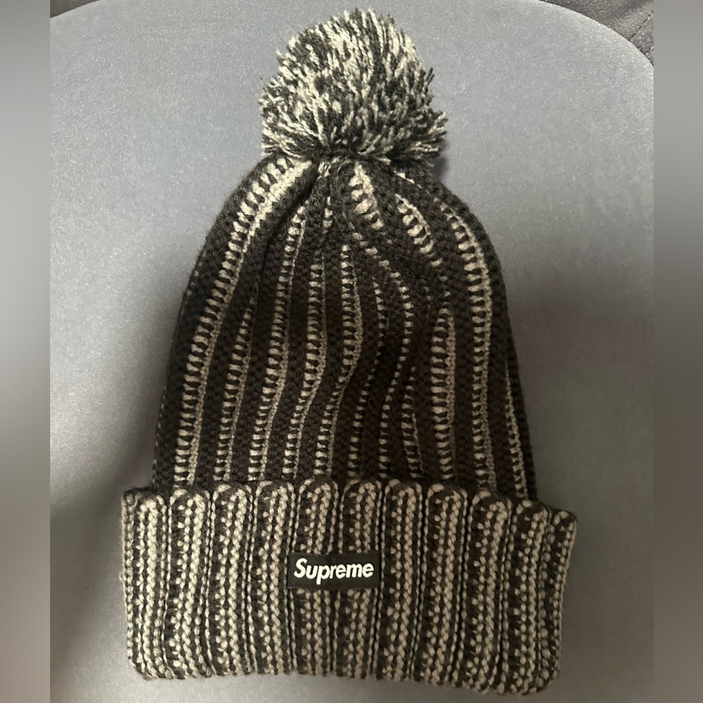 Grey/Black Pom striped Supreme winter hat.